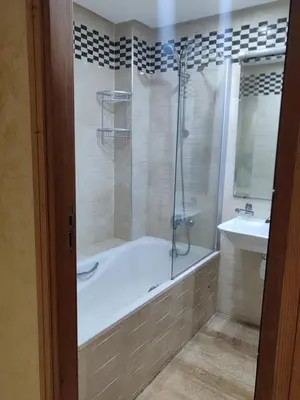 a bathroom with a shower and a tub and a sink at Bonheur Au bord de la mère in Casablanca