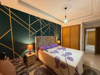 a bedroom with a bed and a wall at Lovely place in Casablanca