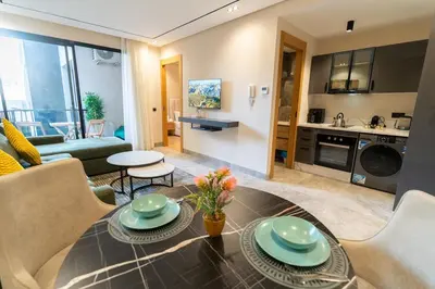a living room with a dining table and a kitchen at Modern & chic studio in Anfa Park, Fast Wifi in Casablanca