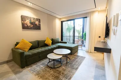 a living room with a couch and a table at Modern & chic studio in Anfa Park, Fast Wifi in Casablanca