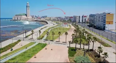 a view of a beach with a kite flying in the sky at Appartament a 2 minute de la mer et la mosquee Hassan 2 in Casablanca-Port