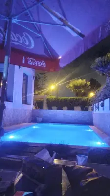a large swimming pool with blue lights in a building at Villa avec piscine proche de la mer in Mohammedia