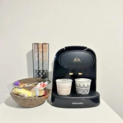 a black coffee maker and a basket of food at ORA Luxoria Suite Racine & Gym by Staycationcasa in Casablanca-Port
