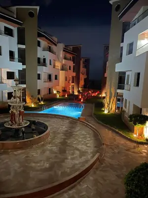 a courtyard with a fountain in front of a building at Résidence Macha'allah in O Ben Slimane