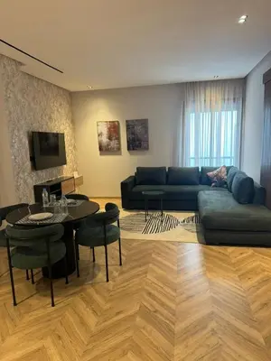a living room with a couch and a table at Selena Modern Studio with Quick Access to Tramway near to Mohamed 5 Stadium in Casablanca in Casablanca