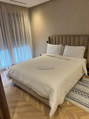 a bedroom with a large white bed and a window at Selena Modern Studio with Quick Access to Tramway near to Mohamed 5 Stadium in Casablanca in Casablanca
