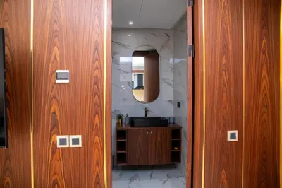 a bathroom with a sink and a wooden door at Peaceful Haven for a Quiet Stay in Maarif 500m to Mohamed Stadium in Casablanca