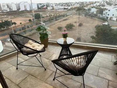 two chairs and a table on a balcony with a view at HERBA Studio - Cozy Space with an Unobstructed View in Bourgogne in Casablanca