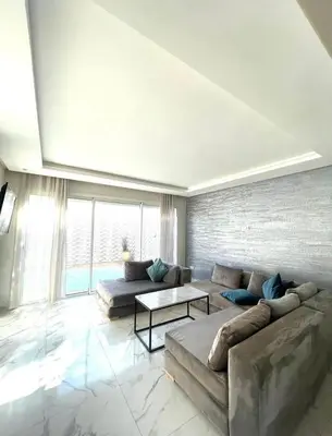 a living room with a couch and a table at Villa Sophia in Dar Bouazza