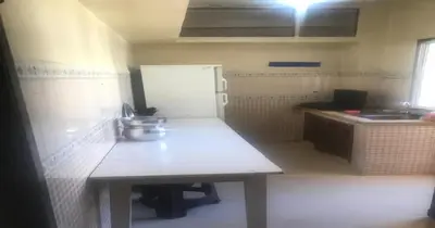 a small kitchen with a table and a sink at Tranquilité au rendez-vous in Casablanca