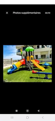 a picture of a playground with a slide at appartement résidence garden paradise plage bouznika in Bouznika