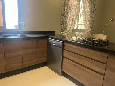 a kitchen with a sink and a dishwasher at Toute commodité in Casablanca