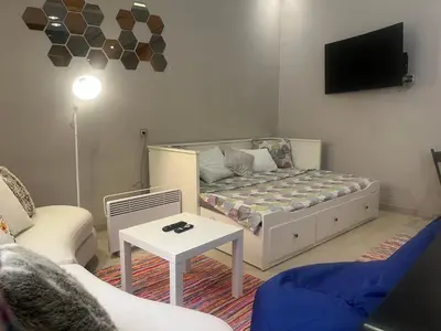 a living room with a couch and a tv at Toute commodité in Casablanca