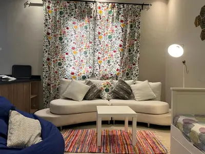 a living room with a couch in front of a curtain at Toute commodité in Casablanca