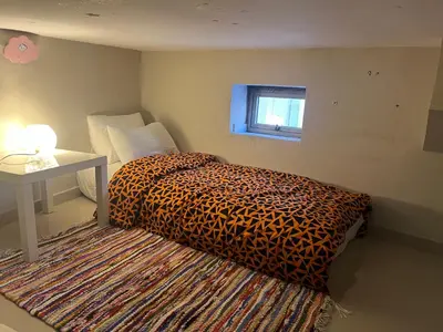 a bedroom with a leopard print bed and a window at Toute commodité in Casablanca