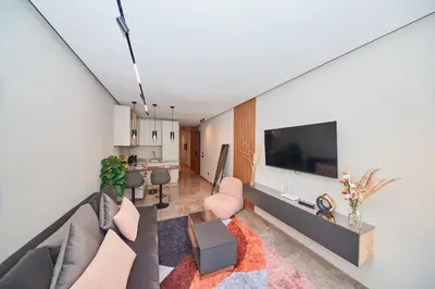 a living room with a couch and a tv at Marilla Studio - Elegant & Peaceful Stay in Bourgogne, Steps from Mohamed V Stadium in Casablanca