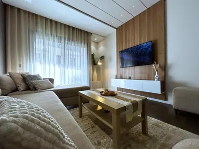 a living room with a couch and a tv on a wall at Premium Studio Central Casablanca in Casablanca