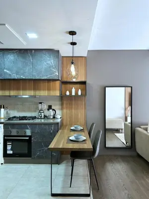 a kitchen with a wooden table and a mirror at Premium Studio Central Casablanca in Casablanca