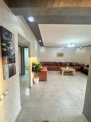 a living room with a couch and a table at Appartement Marbella beach in Mansouria