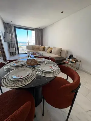 a living room with a table and chairs and a couch at Cosy Studio at B-Living Casa Port Ideal for Business & City Trips with Open View Heart Of Casablanca in Casablanca
