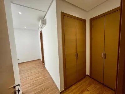 an empty room with wooden doors and a hallway at Urban Chic 2BR - Prestigia near stadium in Rabat