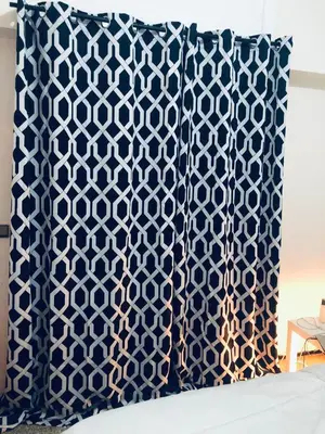 a pillow with a blue and white pattern on it at Chambre cosy vue sur jardin in Mohammedia