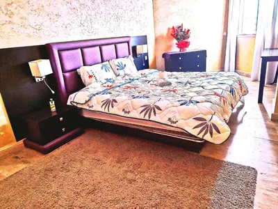 a bedroom with a bed with a purple headboard at Grande appartement 4 chambre in Casablanca