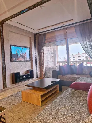 a living room with a couch and a coffee table at Grande appartement 4 chambre in Casablanca
