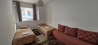a living room with a couch and two beds at Appartement Océan in Rabat