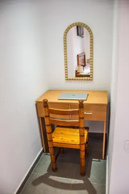 a wooden desk with a mirror and a chair at Modern Apt with sea view and access to the beach in El Harhoura