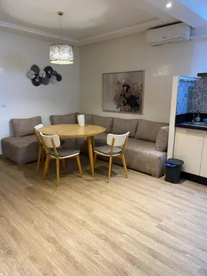a living room with a table and a couch at Joli Appartement 2 pièces in Rabat