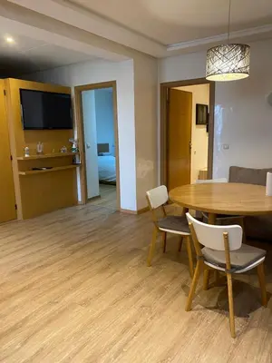 a living room with a dining room table and chairs at Joli Appartement 2 pièces in Rabat