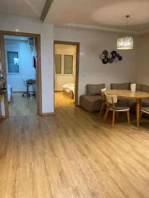 a living room with a table and a couch at Joli Appartement 2 pièces in Rabat