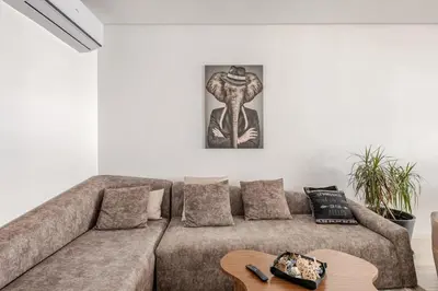 a living room with a couch and a table at La perle de Harhoura Piscine-Océan -Terrain Rabat in Temara