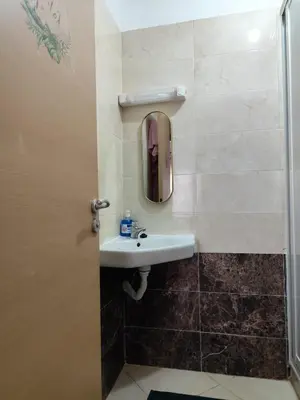 a bathroom with a sink and a mirror at Eco Gare centre 2 chambres in Bouznika