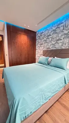 a bedroom with a large blue bed with a wall at Hammersmith 11 in Casablanca
