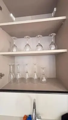 a row of wine glasses on shelves above a sink at Hammersmith 11 in Casablanca