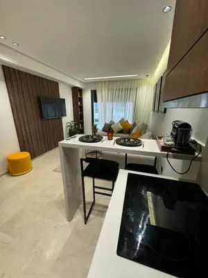 a kitchen with a white island in a room at Studio à louer in Casablanca