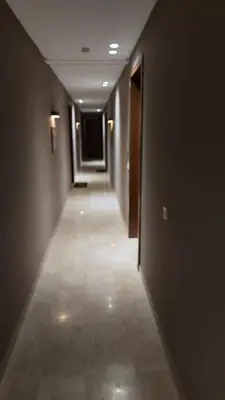 a hallway with a long corridor with a long hallway at Cozy private jacuzzi spa apartment in Casablanca