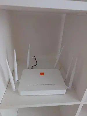 a white router sitting on top of a shelf at Apartment kamal park G39 in Mohammedia