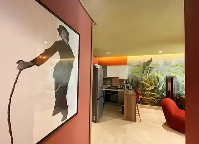 a living room with a painting of a man on a wall at Maya Suites - Luxury Stay in Casablanca in Casablanca