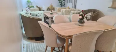 a dining room with a wooden table and chairs at Rabat in Temara
