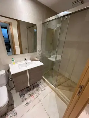 a bathroom with a shower and a sink and a toilet at Appartement dans un cadre convivial in Rabat
