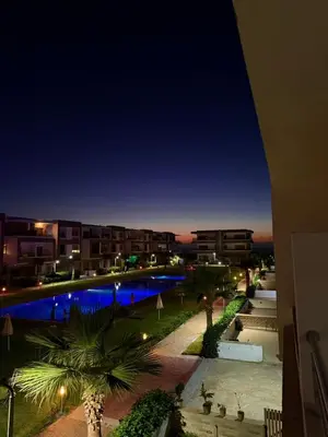 a view of a swimming pool at night at 2BR Beach Apt, Pool, Luxury place in Mansouria