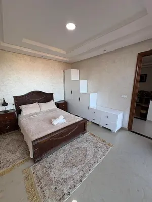 a bedroom with a bed and a dresser and a mirror at VILLA Dar BOUAZZA, Vue sur mer, 200m de la plage in Dar Bouazza