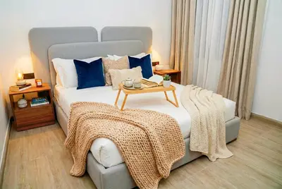 a bedroom with a large bed with a table on it at Maya Suites - Seaside Luxury Apartment in Casablanca
