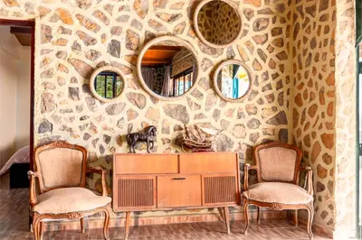 a room with two chairs and a table and two mirrors at La Tulipe de Zaer - Maison de Campagne vue Montagnes - Piscine Privée