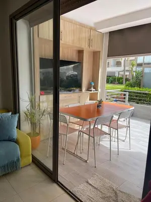 a kitchen and dining room with a table and chairs at Apartment with piscine in Mansouria
