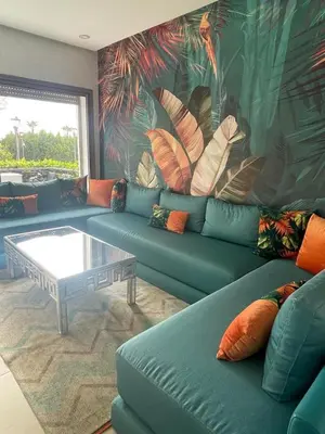 a living room with a couch and a coffee table at Apartment with piscine in Mansouria