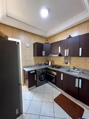 a kitchen with a sink and a dishwasher at artisanat in Mohammedia
